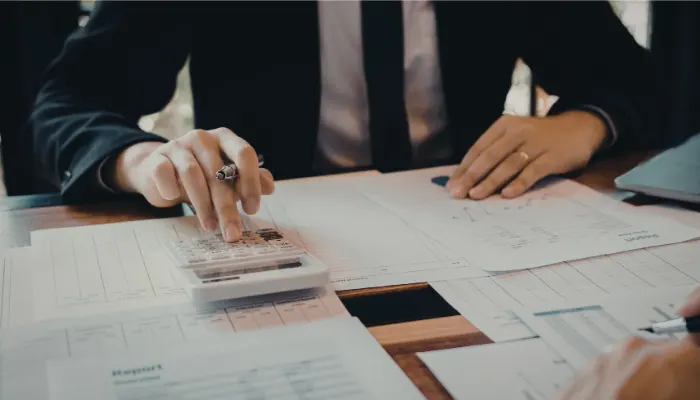 Person calculating finances on paperwork