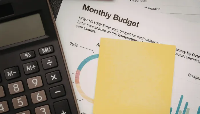 Monthly budget sheet with calculator and notes
